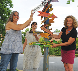 Instructors with Children's Literature sign