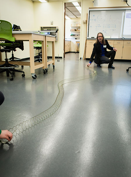 Photo of professor in lab with Slinky