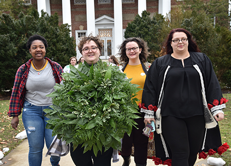 Photo of students carrying wreath