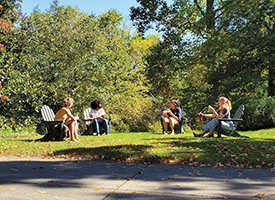 Hollins students talking while socially distancing