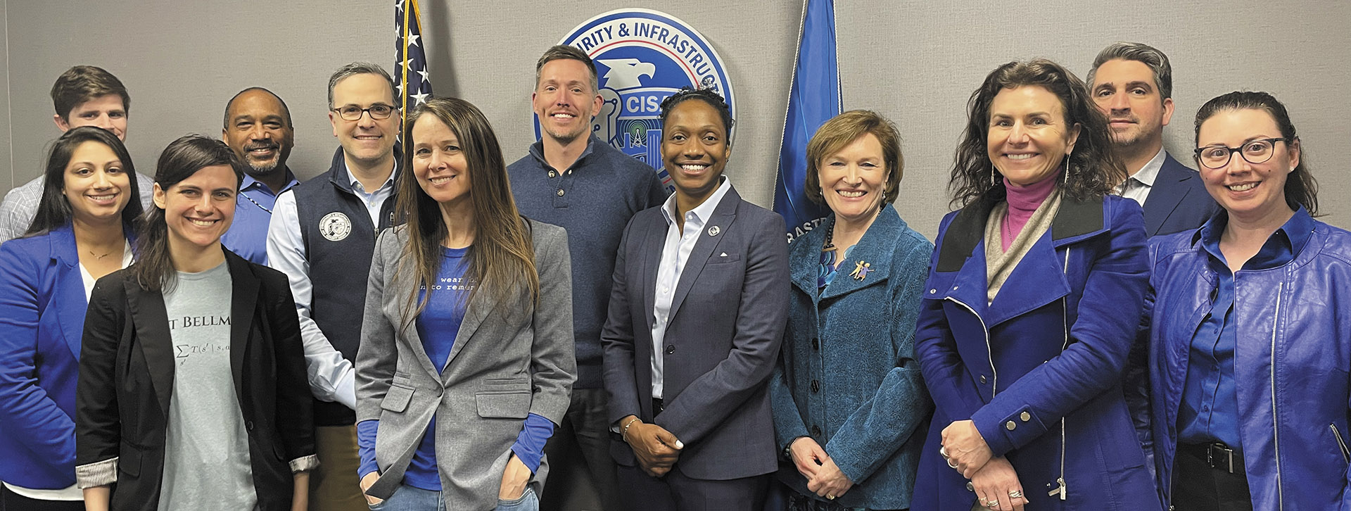 Elizabeth Kolmstetter '85 poses with CISA colleagues for a "Wear Blue" in support of Human Trafficking Awareness Day in January 2023.