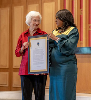 President Mary Dana Hinton presents special resolution to Paula Brownlee