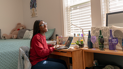 Student at desk in dorm room