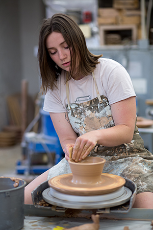 Student creating pottery