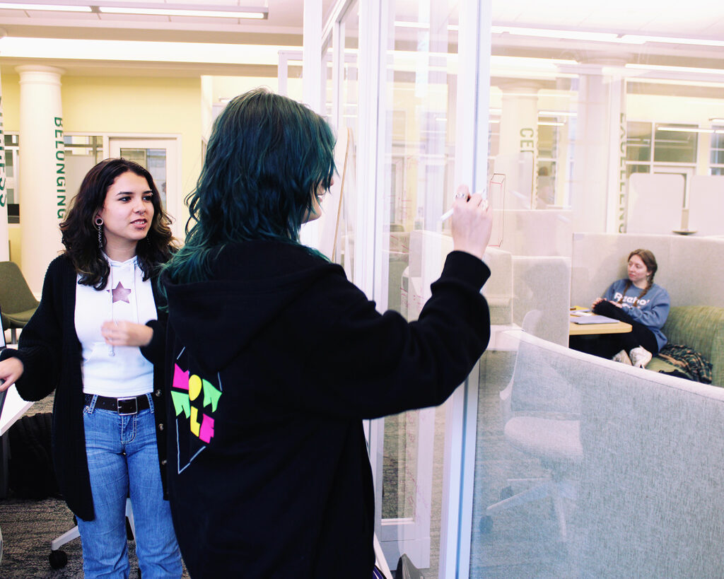 Center for Learning Excellence - Students writing on glass board